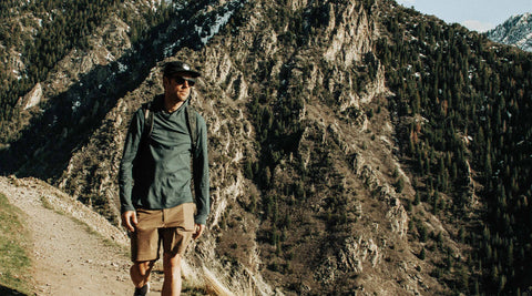 Alex walking down a mountainside trail.