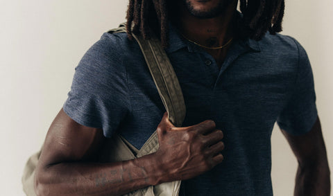 fit model posing in The Merino Polo in Heather Navy