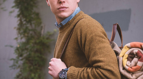 Close-cropped image of John, wearing a backpack and rocking our sweater.