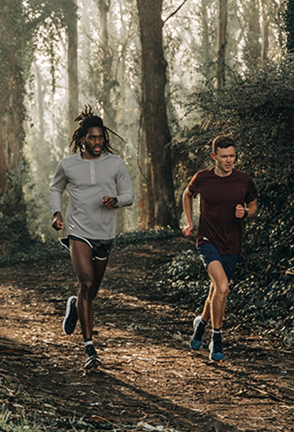 Two men running in the forested woods of the Marin Headlands