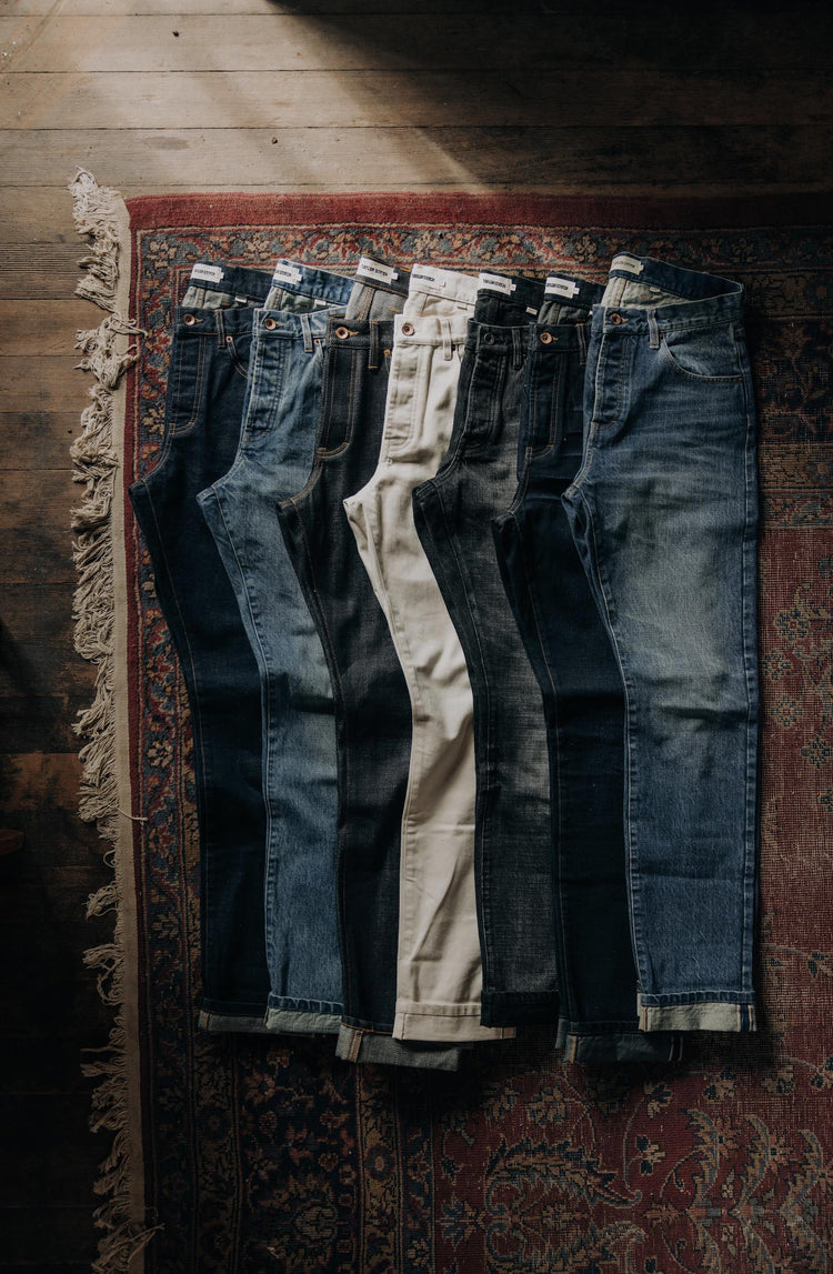 various TS denim laid out on decorative rug