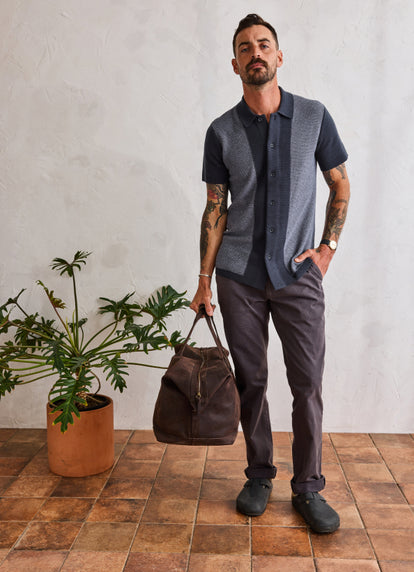 Model wearing The Button Down Polo in Marine Seed Stitch and The Foundation Pant in Organic Coal