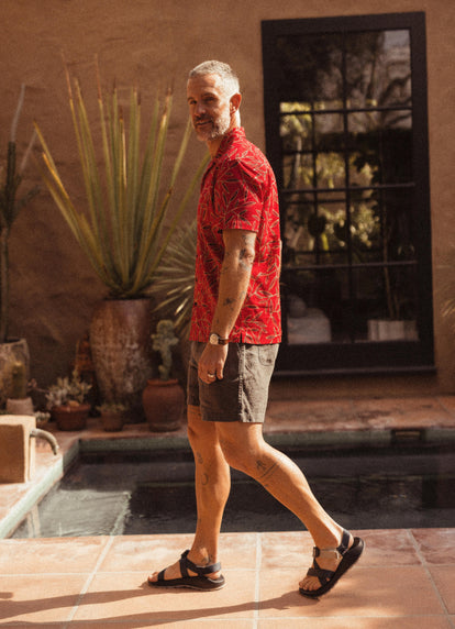 Model walking by the pool in The Short Sleeve Hawthorne, The Après Short and The Z1 USA Classic Sandal in Navy Waffle