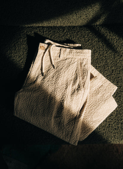 The Easy Pant in Natural Seersucker in a shaft of sunlight