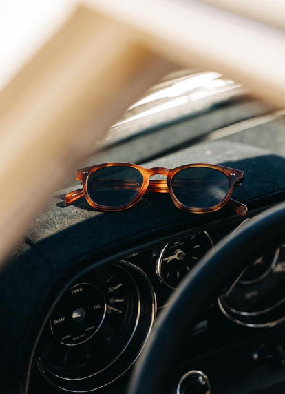 Tortoise shell Legend sunglasses on the car dashboard