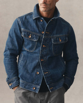 fit model posing in The Long Haul Jacket in Mid Wash Organic Selvedge