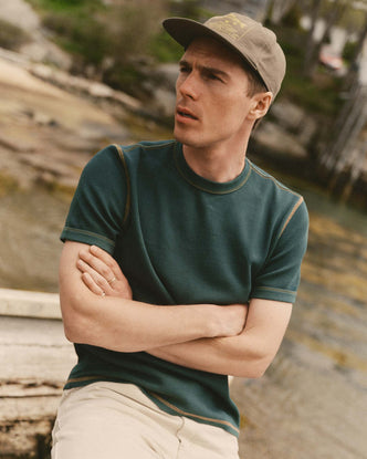 fit model sitting wearing The Organic Cotton Short Sleeve Crew in Dark Forest Waffle