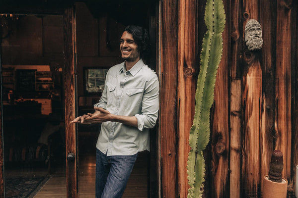 fit model posing against the wall in The Western Shirt in Washed Denim
