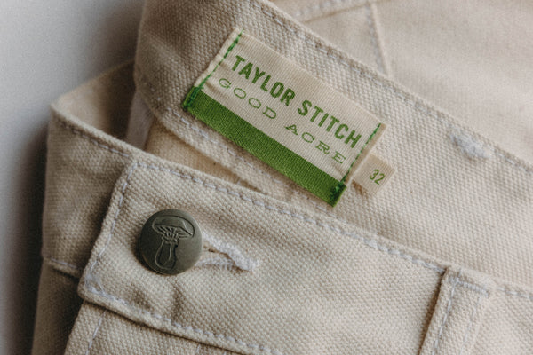 editorial image of the button on The Good Acre Chore Pant in Natural Canvas