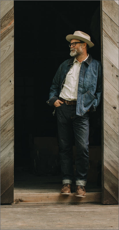 Mark Holthusen standing in a wooden barn at Springhill Farm