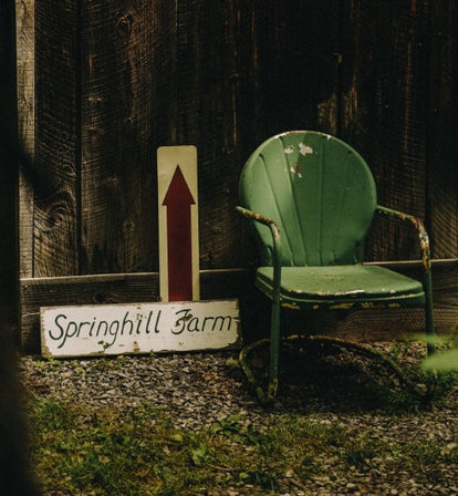 Green chair and Springhill Farm sign