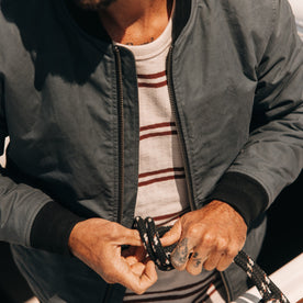 fit model tying a sailing line in The Bomber Jacket in Charcoal Dry Wax