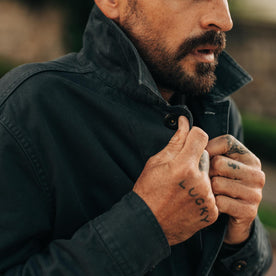 fit model buttoning up The Ojai Jacket in Organic Navy Foundation Twill