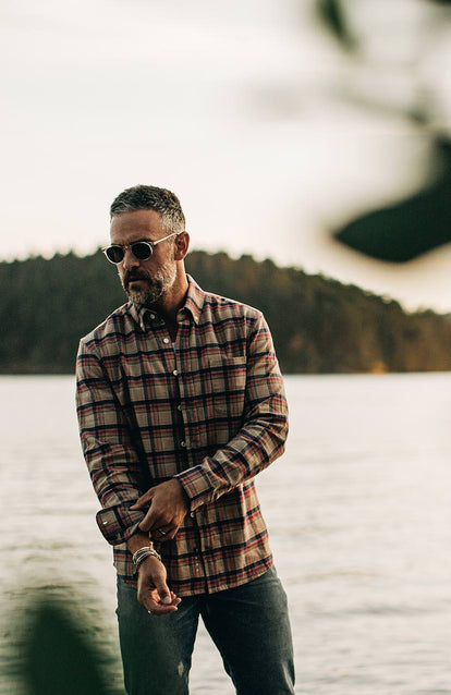 A man wearing a plaid shirt on the beach in the Pacific Northwest.