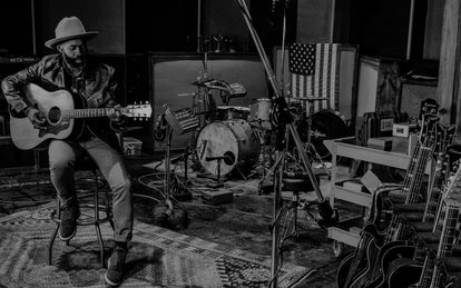 Kirk playing guitar in a studio in Dallas.