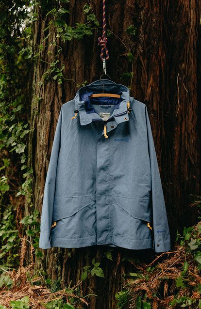 The Owens Parka hanging on a tree in the woods