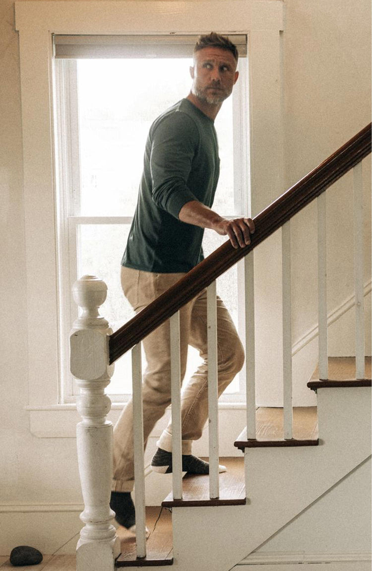 Model going up the stairs in The Cotton Hemp Long Sleeve Tee in Dark Forest