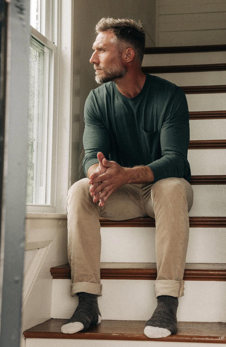 Model sitting on the stairs in The Cotton Hemp Long Sleeve Tee in Dark Forest