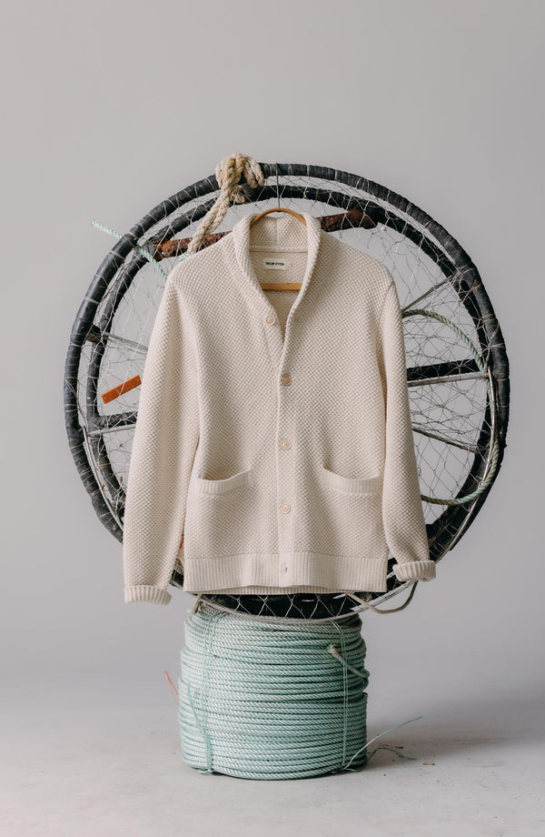 editorial image of The Crawford Sweater in Marled Natural hanging