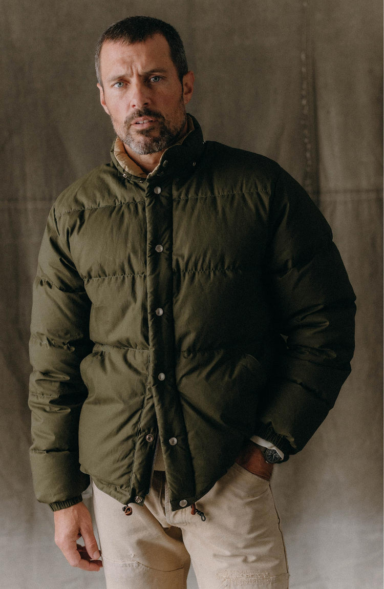 fit model posing in The Down Sweater in Olive Waxed Ripstop