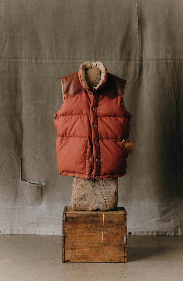 editorial image of The Down Vest in Brick Red Waxed Ripstop hanging