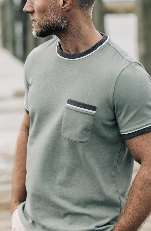 Our model standing in the heavy bag ringer tee in slate and seed
