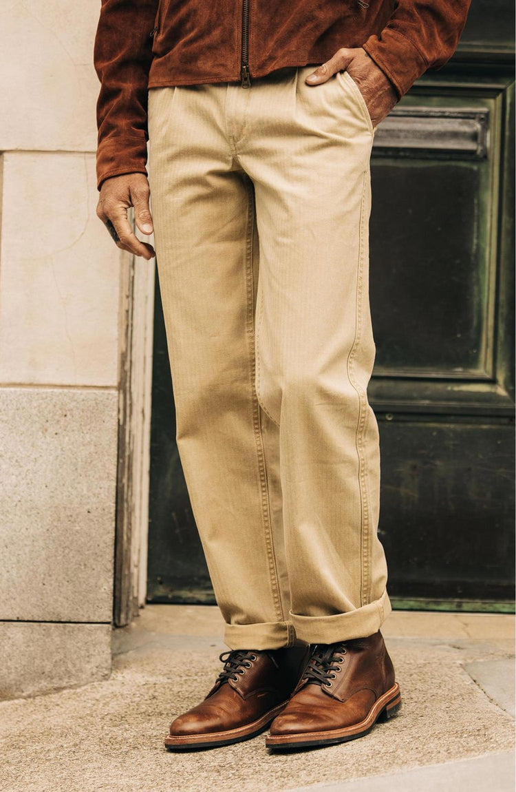 fit model with his hand in his pocket of The Matlow Pant in Light Khaki Pigment Herringbone