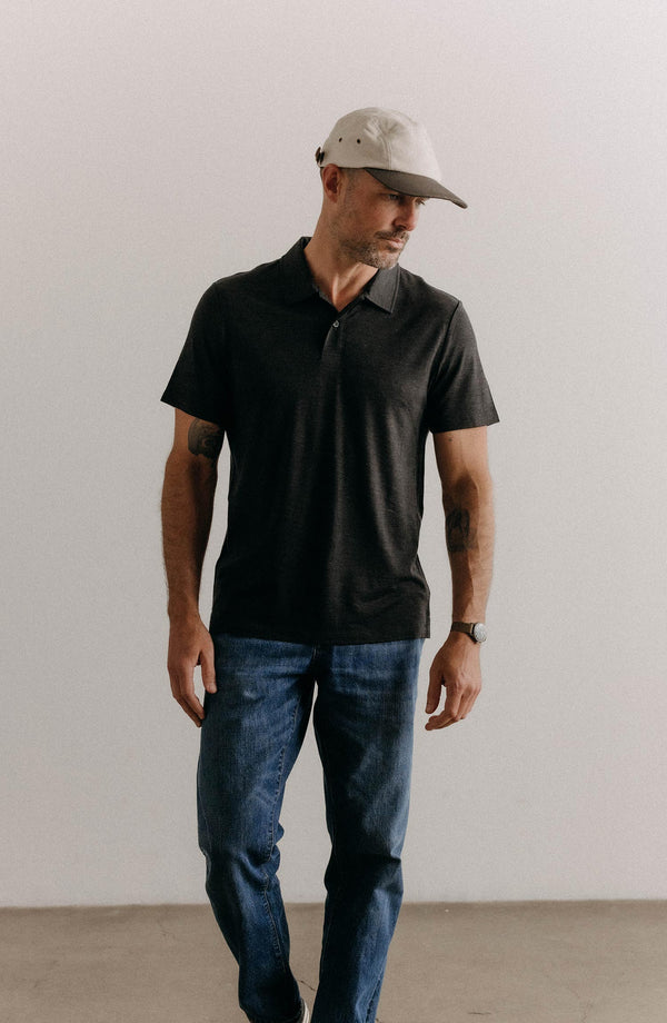 fit model posing in The Merino Polo in Heather Black