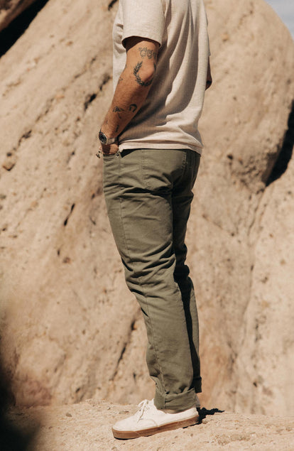 Our model standing in The Slim All Day Pant in Arid Eucalyptus Canvas