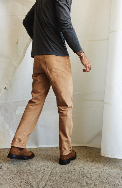 fit model showing off the back of The Slim All Day Pant in Tobacco Selvage Denim