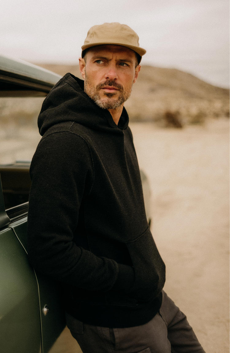 fit model with his hands in his pockets wearing The Apres Hoodie in Black Indigo Terry