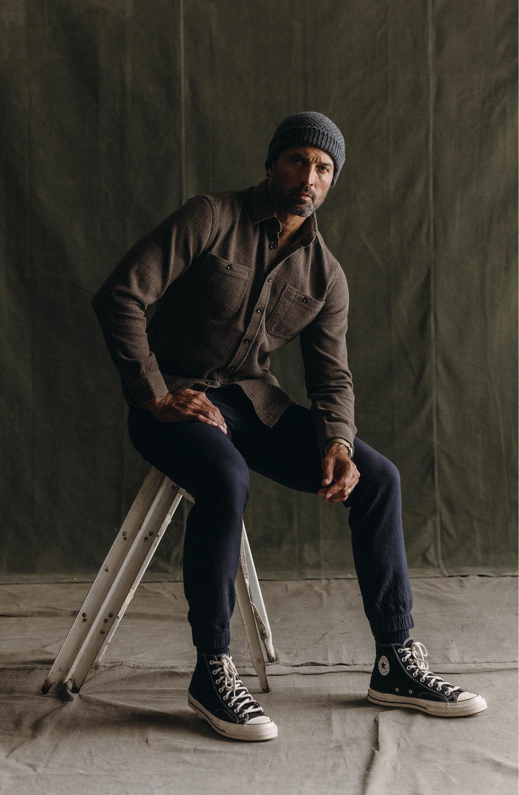 fit model sitting wearing The Apres Pant in Coal Double Cloth
