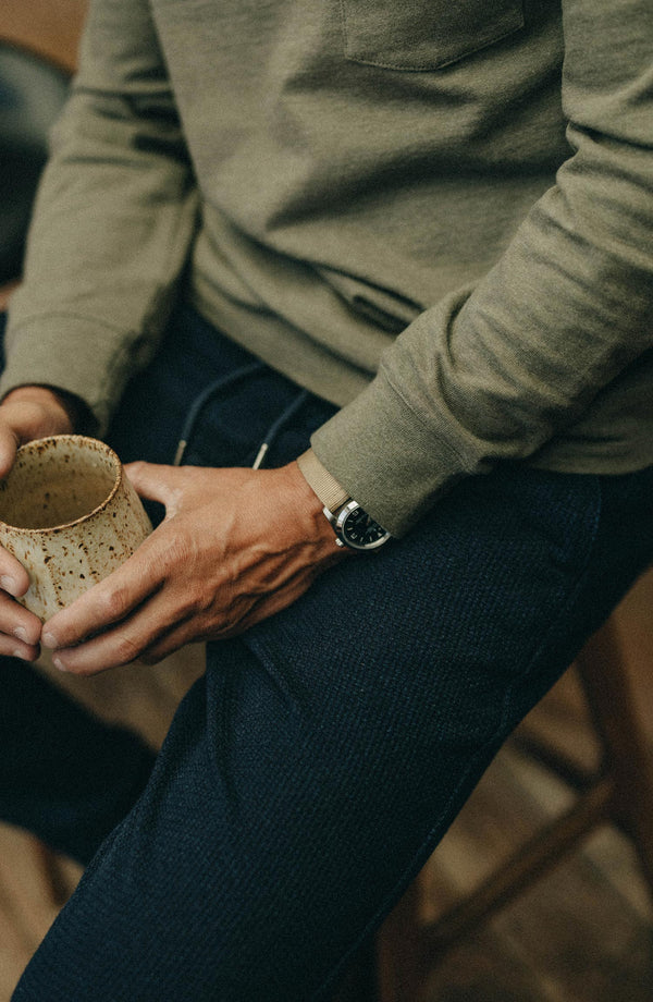 editorial flatlay of The Apres Pant in Rinsed Indigo Sashiko next to other apres pant