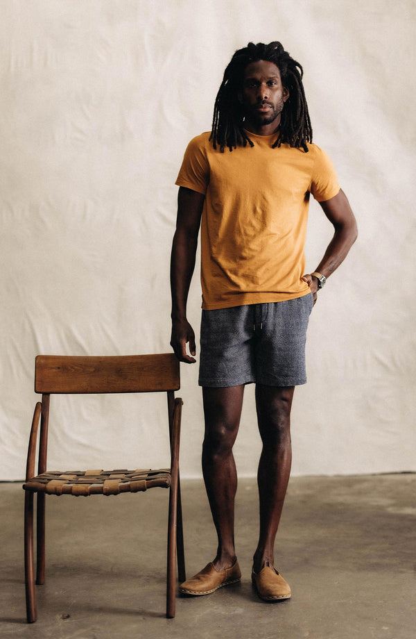 fit model with his hands in his pockets wearing The Apres Short in Navy Linen Tweed