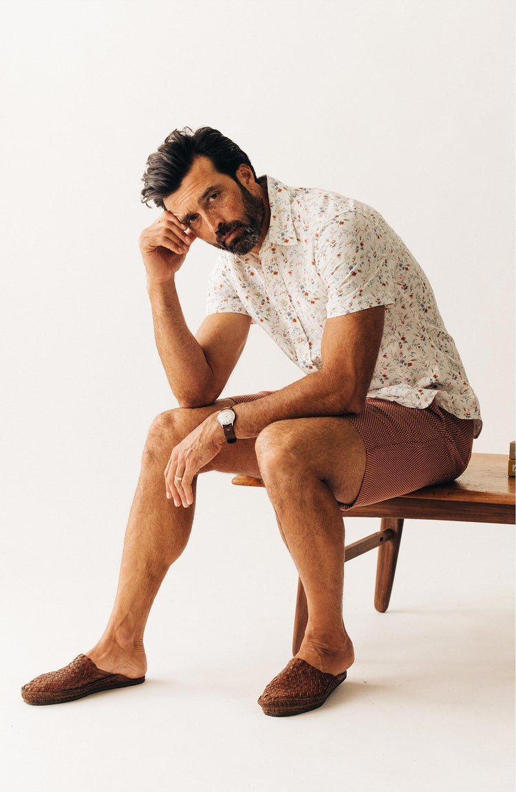 fit model sitting wearing The Apres Short in Fired Brick Dobby