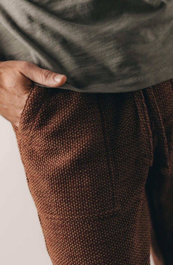 fit model showing off the pocket on The Breakwater Pant in Black Cherry Sashiko