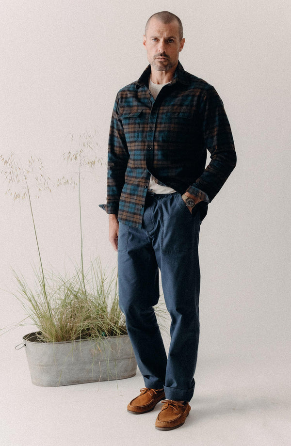 fit model with his hand in his pocket wearing The Breakwater Pant in Dark Navy Ripstop