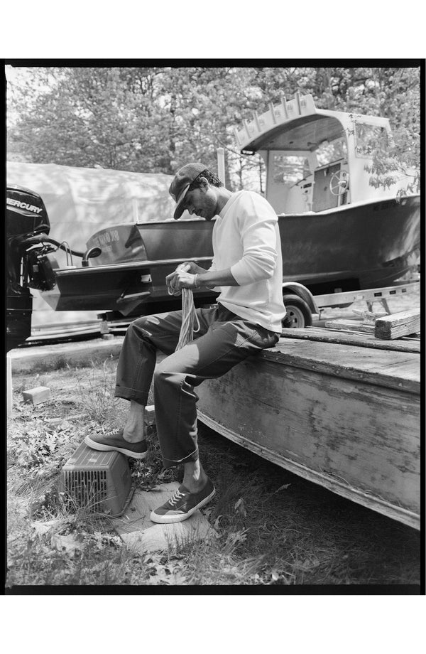 fit model sitting wearing The Breakwater Pant in Mushroom Ripstop