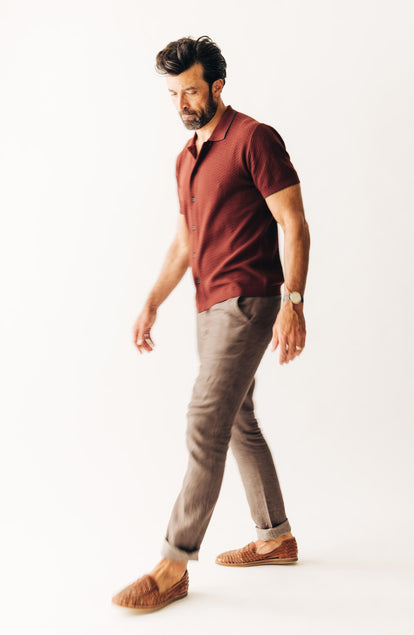 fit model walking wearing The Button Down Polo in Dried Cherry Herringbone