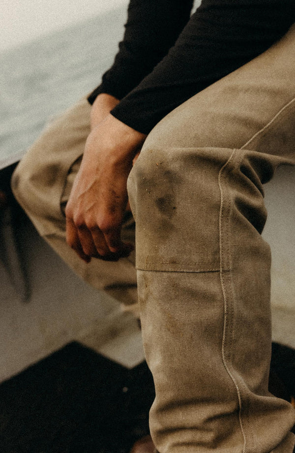 fit model walking on rocks wearing The Chore Pant in Stone Chipped Canvas