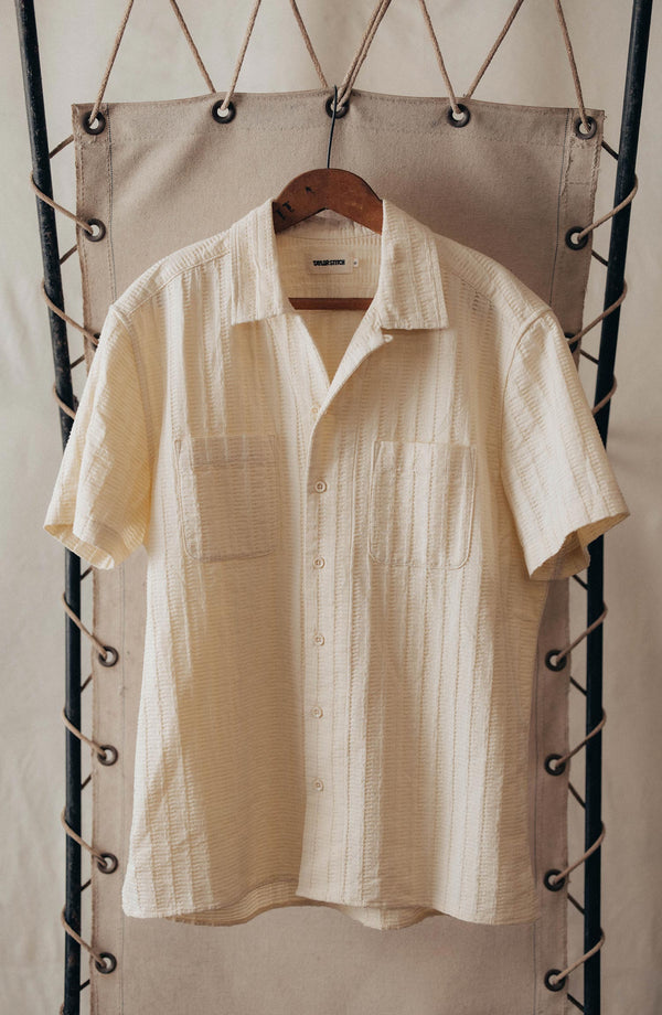 editorial image of The Conrad Shirt in Vintage White Dobby Stripe hanging