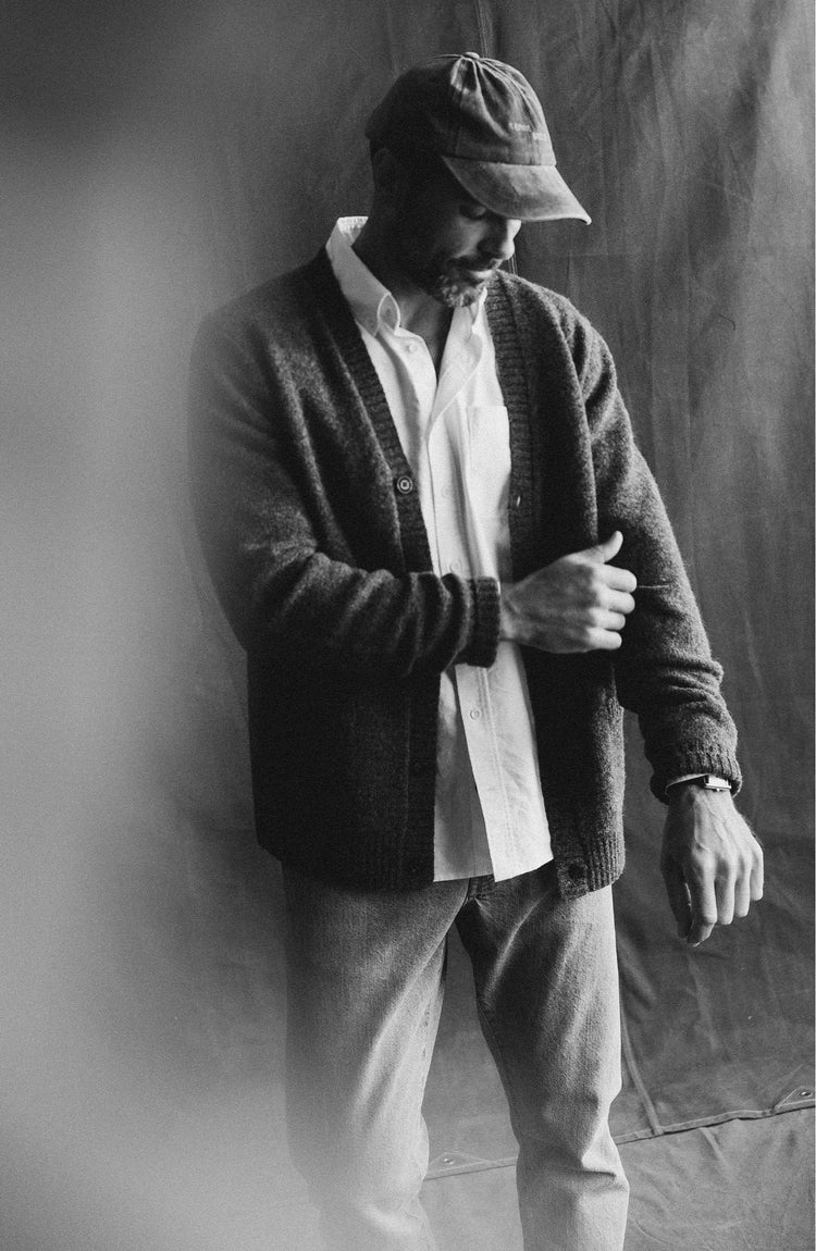 fit model adjusting The Eastmoor Cardigan in Heather Graphite Wool