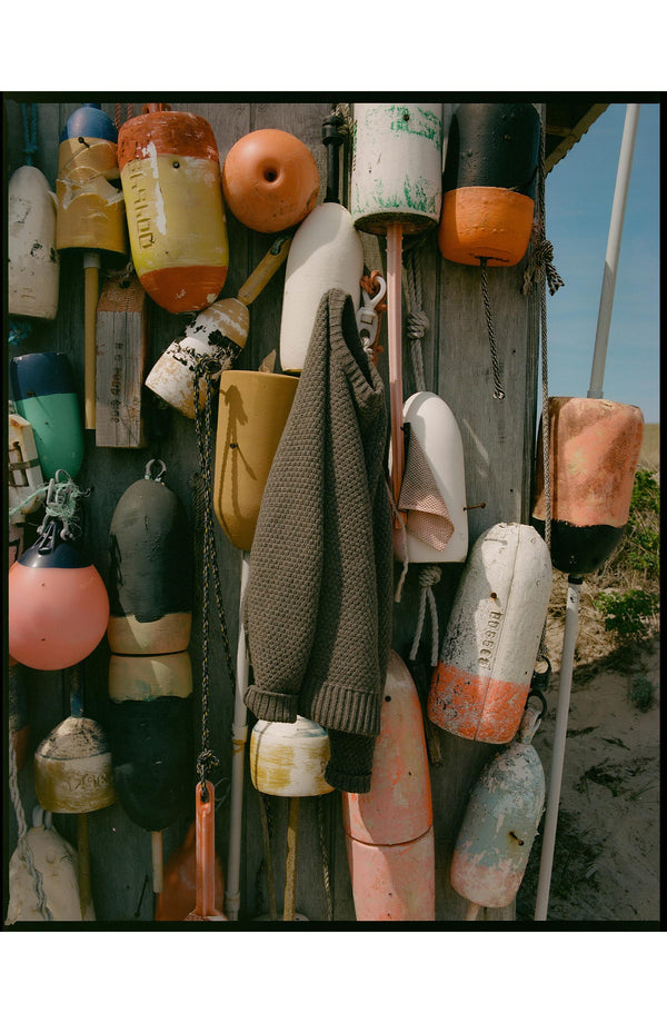 editorial image of The Fisherman Sweater in Taupe Merino on a dock