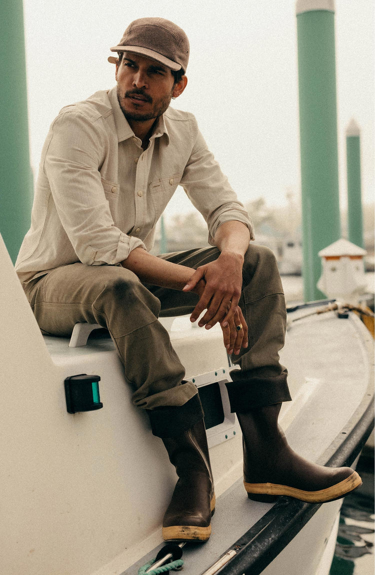 fit model sitting wearing The Foundry Shirt in Natural Chambray