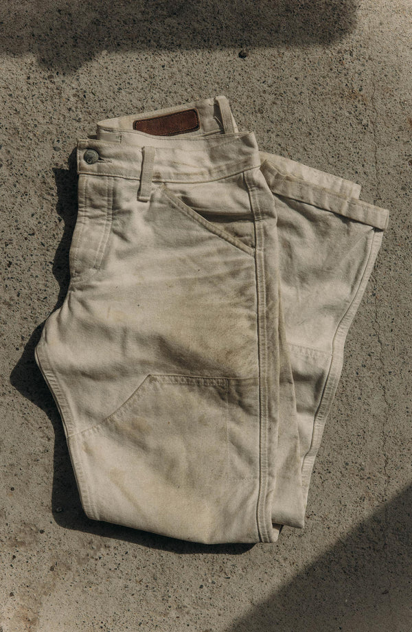 folded flatlay of The Good Acre Chore Pant in Natural Canvas