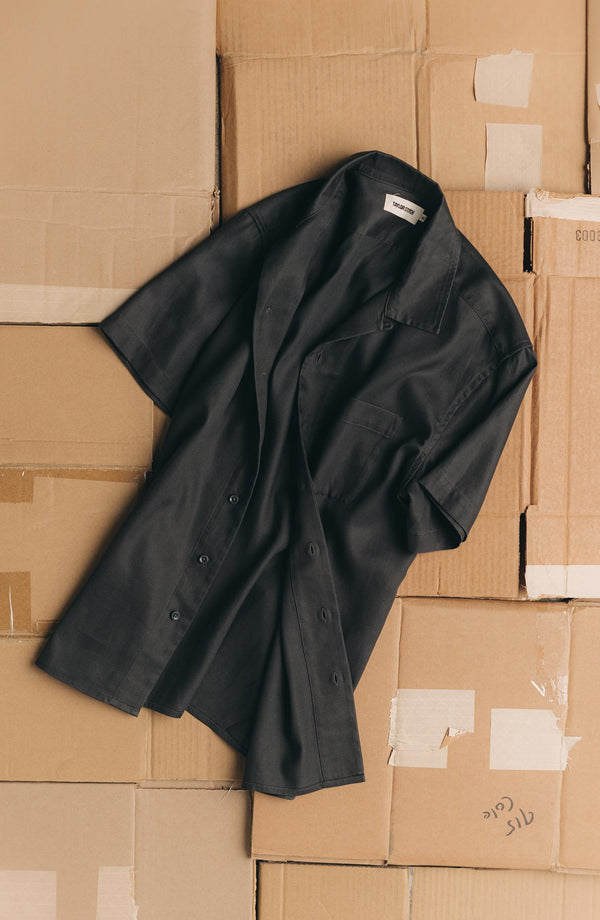 editorial flatlay of The Hawthorne Shirt in Asphalt on cardboard