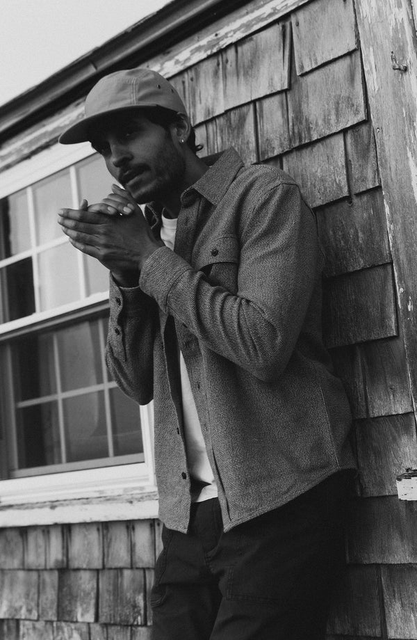 fit model leaning agains the wall wearing The Ledge Shirt in Army Linen Tweed