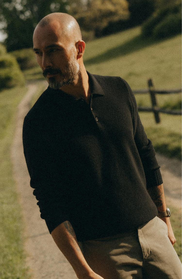fit model walking wearing The Newton Sweater Polo in Midnight Merino