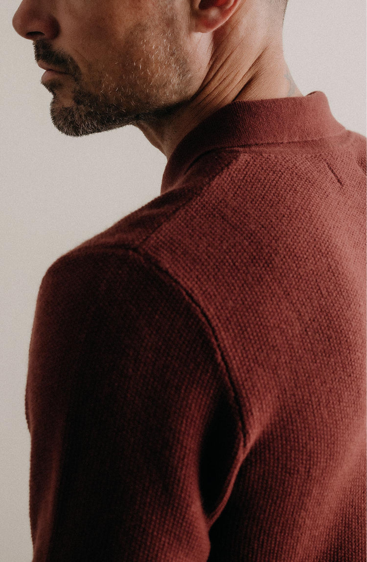 fit model showing off the back of The Newton Sweater Polo in Dried Cherry Merino