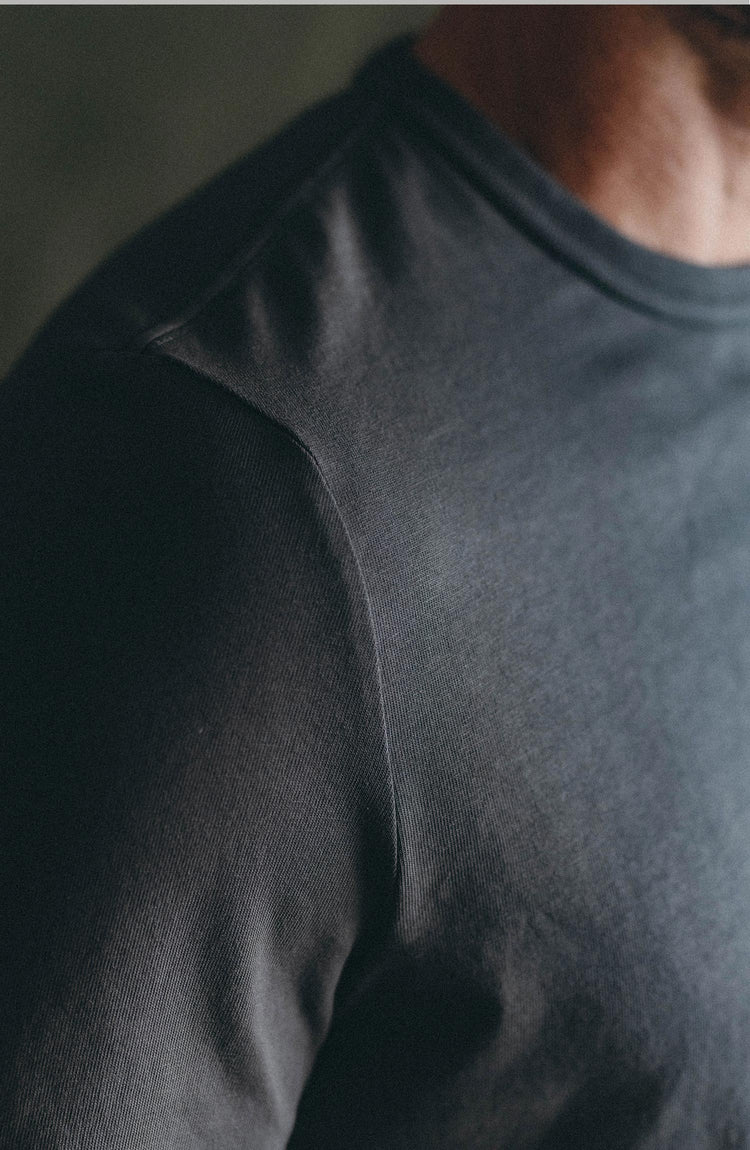 fit model posing in The Organic Cotton Long Sleeve Tee in Faded Black